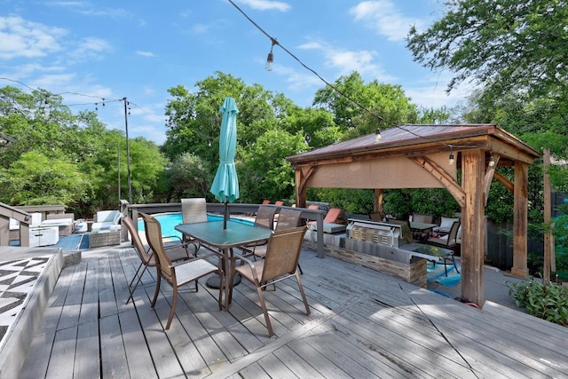 12001 Bittern Holw, Austin, TX 78758 - wooden terrace featuring a gazebo, outdoor dining space, an outdoor kitchen, and outdoor lounge area