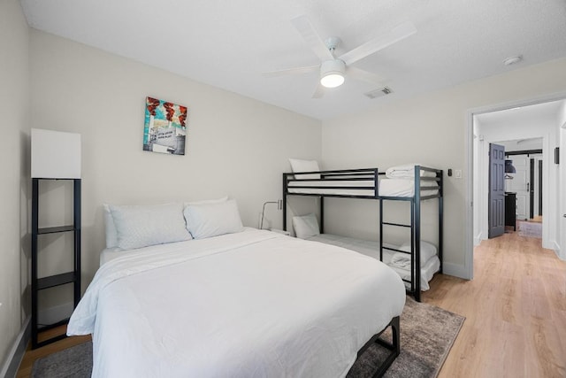 12001 Bittern Holw, Austin, TX 78758 - bedroom with light wood-style floors and ceiling fan