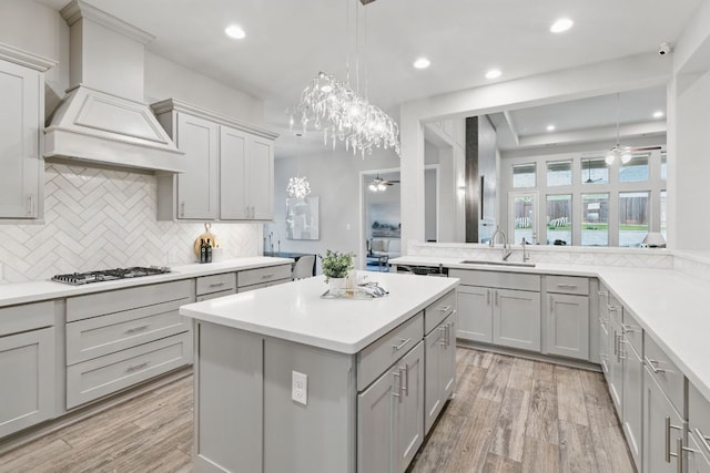kitchen with a ceiling fan, gray cabinetry, decorative backsplash, light wood finished floors, and recessed lighting