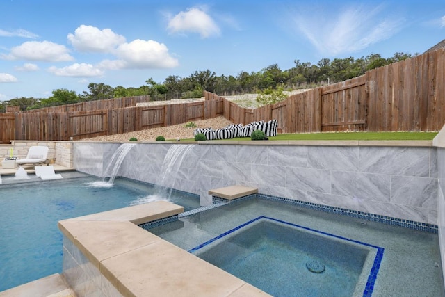 view of swimming pool featuring a fenced backyard and a pool with connected hot tub