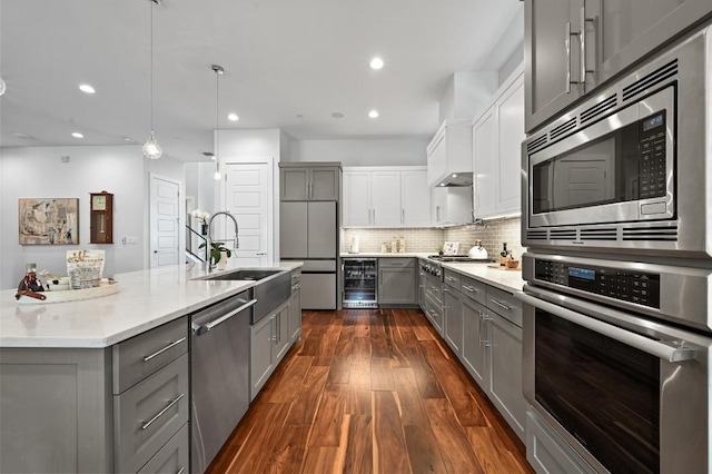 3102 Hunt Trl, Austin, TX 78757 - kitchen featuring gray cabinets, built in appliances, beverage cooler, a sink, and recessed lighting