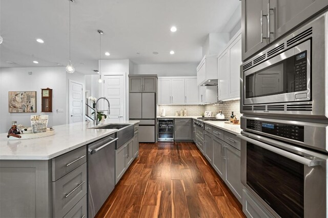 3102 Hunt Trl, Austin, TX 78757 - kitchen with built in appliances, gray cabinetry, beverage cooler, a sink, and recessed lighting