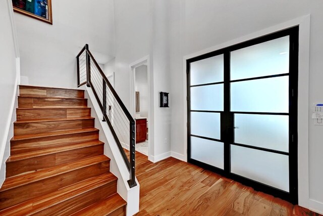 3102 Hunt Trl, Austin, TX 78757 - stairs with wood finished floors, baseboards, and a high ceiling