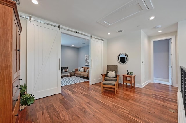 3102 Hunt Trl, Austin, TX 78757 - sitting room featuring a barn door, wood finished floors, attic access, baseboards, and recessed lighting