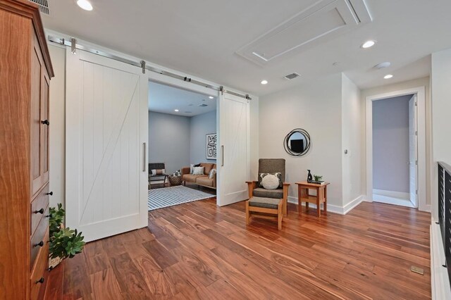 3102 Hunt Trl, Austin, TX 78757 - sitting room featuring a barn door, wood finished floors, attic access, baseboards, and recessed lighting