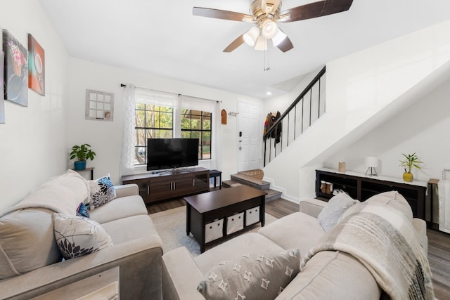 living room with wood finished floors, stairs, a ceiling fan, and recessed lighting