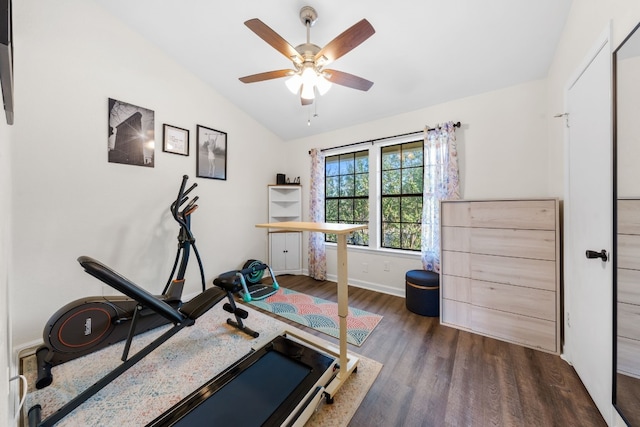 exercise room with lofted ceiling, wood finished floors, a ceiling fan, and baseboards