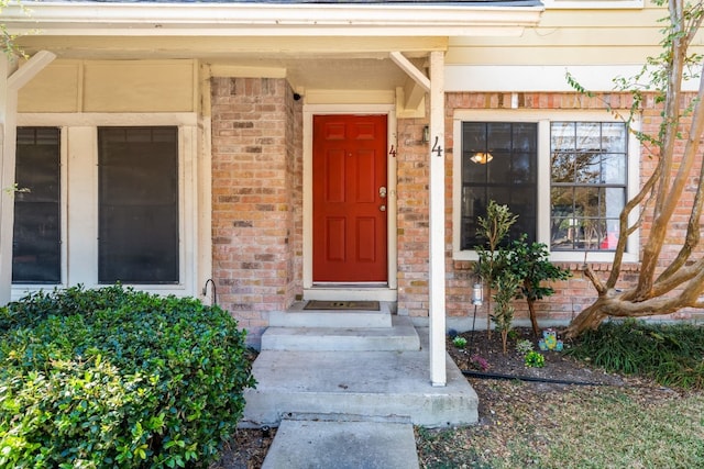 property entrance with brick siding