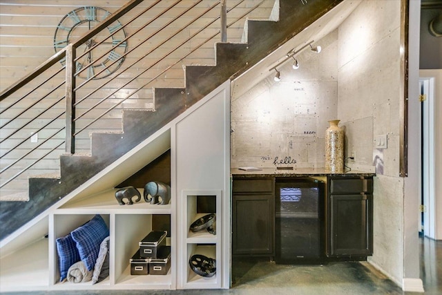 5307 Shady Oaks Cir, Kingsland, TX 78639 - indoor bar with wine cooler, concrete flooring, stairs, and rail lighting