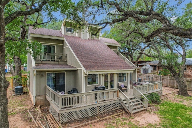 5307 Shady Oaks Cir, Kingsland, TX 78639 - back of house with a shingled roof, fence, central AC, a balcony, and a wooden deck