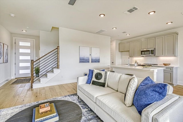 2600 Gattis School Rd Unit 401, Round Rock, TX 78664 - living room with baseboards, light wood-style floors, recessed lighting, and stairs