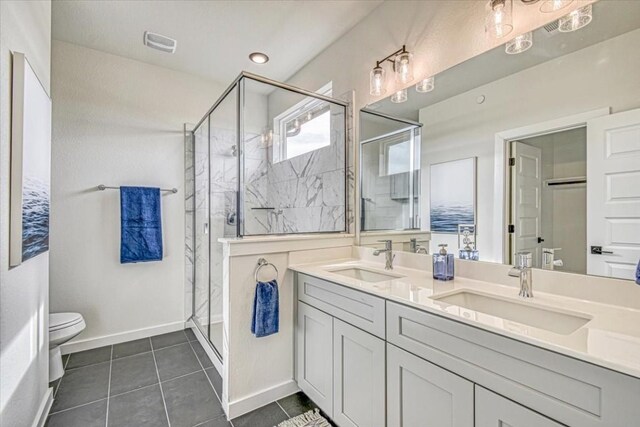 2600 Gattis School Rd Unit 401, Round Rock, TX 78664 - full bathroom featuring toilet, a stall shower, tile patterned floors, double vanity, and baseboards