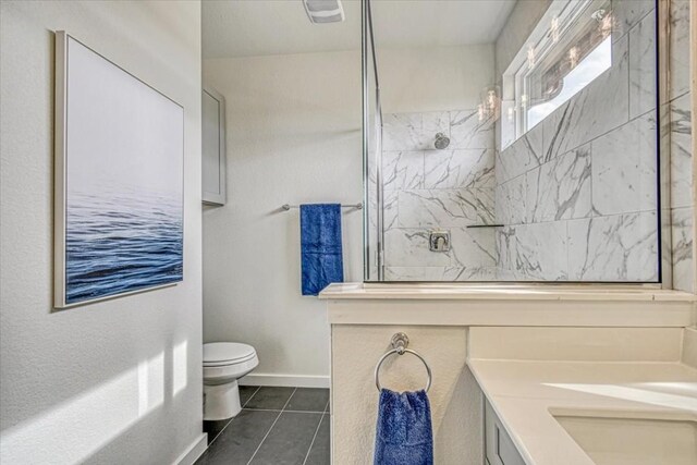2600 Gattis School Rd Unit 401, Round Rock, TX 78664 - full bath featuring a marble finish shower, tile patterned flooring, toilet, double vanity, and baseboards