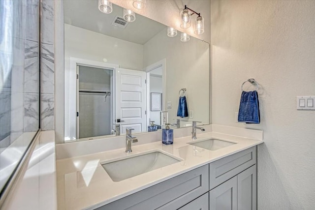 2600 Gattis School Rd Unit 401, Round Rock, TX 78664 - full bathroom with double vanity and a textured wall