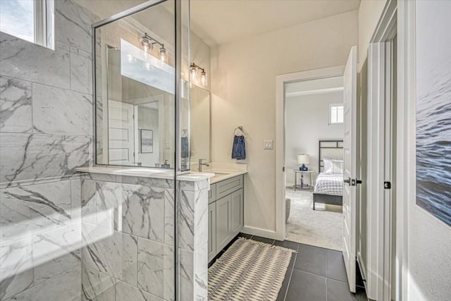 2600 Gattis School Rd Unit 401, Round Rock, TX 78664 - bathroom with a marble finish shower, connected bathroom, vanity, and tile patterned floors