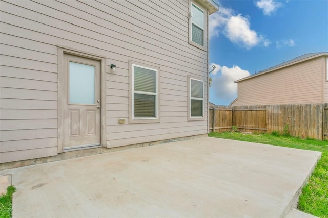 back of house featuring a patio area and a fenced backyard