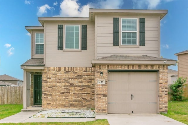 view of front facade with fence, brick siding, an attached garage, and driveway