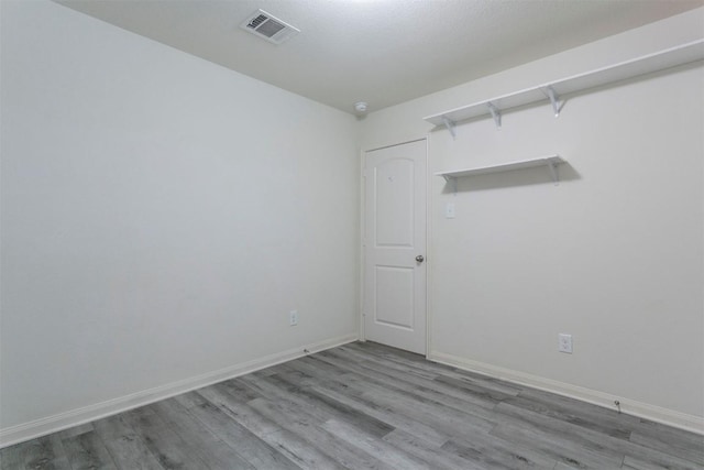 empty room with wood finished floors and baseboards