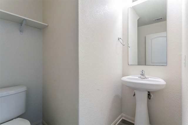 half bath featuring toilet