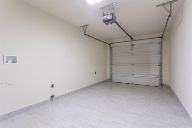 garage with a garage door opener and baseboards