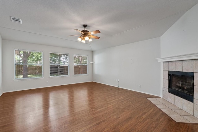4329 Rock Hill Rd, Round Rock, TX 78681 - unfurnished living room with wood finished floors, a ceiling fan, and a tile fireplace