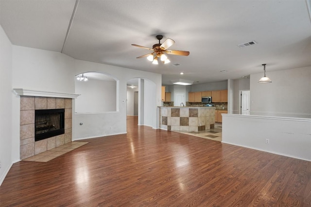 4329 Rock Hill Rd, Round Rock, TX 78681 - unfurnished living room with ceiling fan, light wood-style flooring, a fireplace, and baseboards