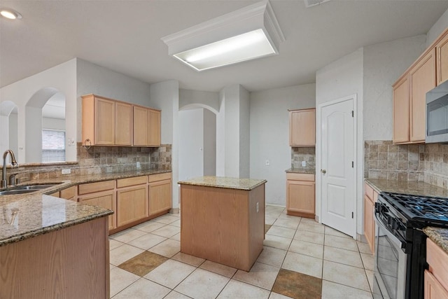 4329 Rock Hill Rd, Round Rock, TX 78681 - kitchen featuring light brown cabinetry, gas range, backsplash, and light stone countertops