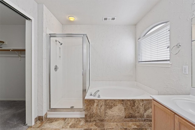 4329 Rock Hill Rd, Round Rock, TX 78681 - bathroom featuring a stall shower, vanity, a bath, and a walk in closet