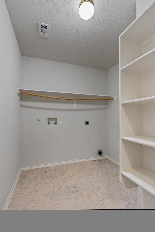 4329 Rock Hill Rd, Round Rock, TX 78681 - laundry room with electric dryer hookup, a textured ceiling, hookup for a washing machine, gas dryer hookup, and baseboards