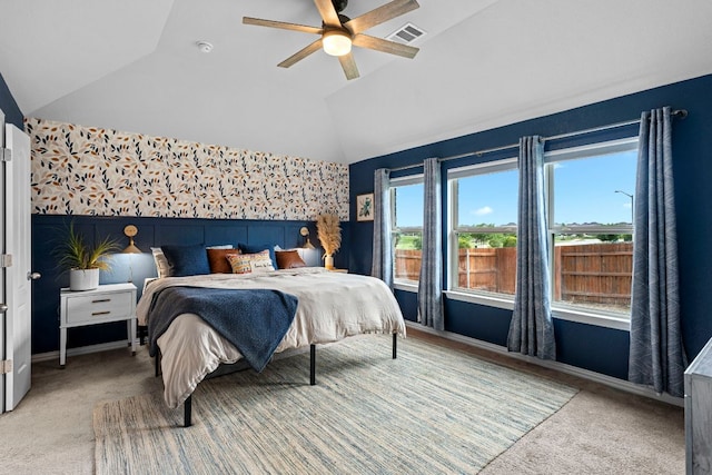 115 Oleander Loop, Buda, TX 78610 - bedroom featuring vaulted ceiling, light carpet, a wainscoted wall, and a ceiling fan