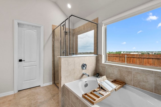 115 Oleander Loop, Buda, TX 78610 - bathroom with a stall shower, a bath, tile patterned flooring, and lofted ceiling