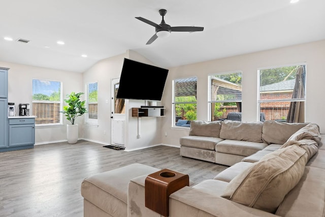 living area with wood finished floors, vaulted ceiling, a ceiling fan, recessed lighting, and baseboards