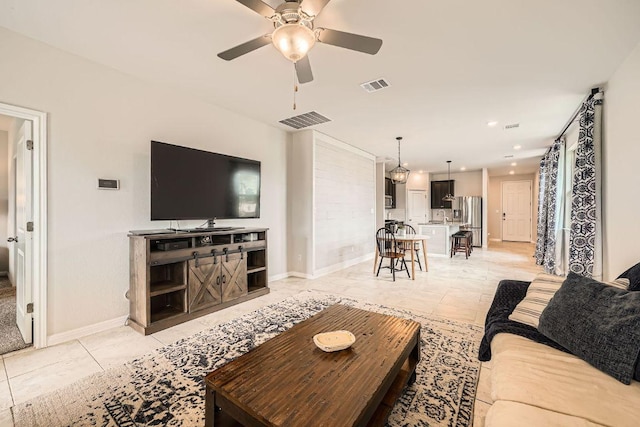 living room with light tile patterned flooring, ceiling fan, baseboards, and recessed lighting