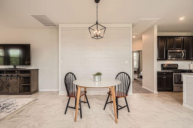 dining space featuring attic access, baseboards, and light tile patterned flooring