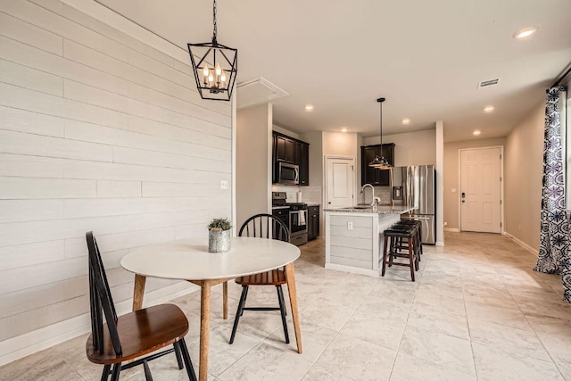 dining area with recessed lighting, light tile patterned floors, and baseboards