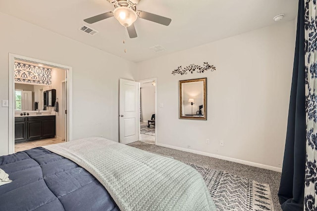 bedroom with light colored carpet, baseboards, connected bathroom, and a ceiling fan
