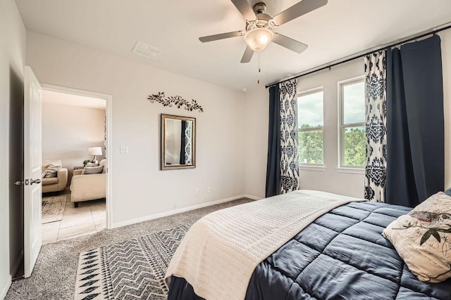 carpeted bedroom with baseboards and ceiling fan