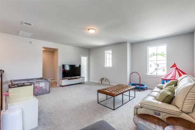 1611 Sawmill Xing, Round Rock, TX 78665 - living area featuring plenty of natural light, carpet floors, and baseboards