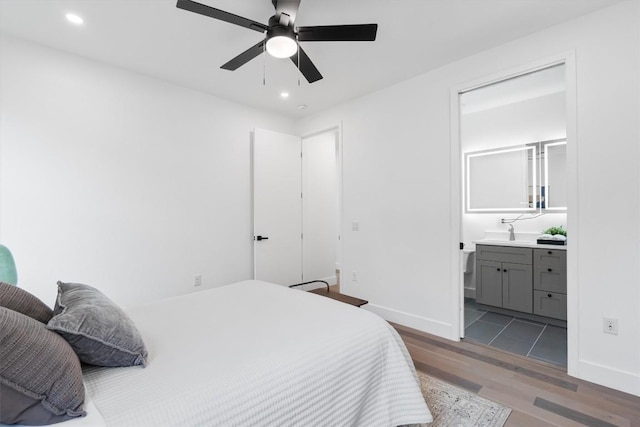 1208 W Oltorf St Unit B, Austin, TX 78704 - bedroom with wood finished floors, recessed lighting, ensuite bathroom, baseboards, and a sink