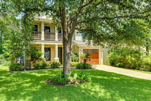 2112 W 11th St, Austin, TX 78703 - view of front of property featuring stone siding, a balcony, a front yard, and a standing seam roof