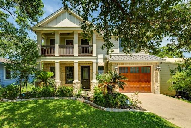 2112 W 11th St, Austin, TX 78703 - view of front facade featuring a balcony, stone siding, a porch, a standing seam roof, and driveway