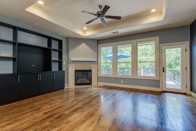 2112 W 11th St, Austin, TX 78703 - unfurnished living room with a tray ceiling, crown molding, healthy amount of natural light, hardwood / wood-style floors, and recessed lighting