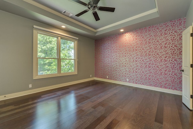 2112 W 11th St, Austin, TX 78703 - spare room featuring wallpapered walls, dark wood-style flooring, a ceiling fan, a tray ceiling, and baseboards