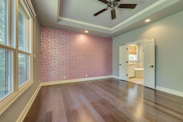 2112 W 11th St, Austin, TX 78703 - spare room featuring wallpapered walls, dark wood-style flooring, ceiling fan, baseboards, and ornamental molding