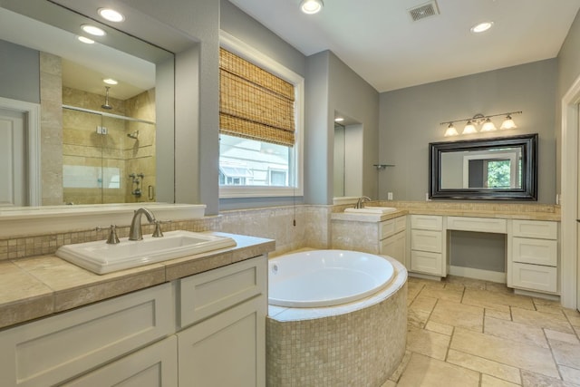 2112 W 11th St, Austin, TX 78703 - bathroom featuring a shower stall, a bath, stone tile floors, two vanities, and recessed lighting