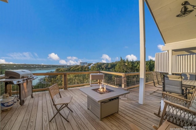 693 Riviera Dr, Canyon Lake, TX 78133 - deck featuring an outdoor fire pit, a grill, a water view, and outdoor dining space