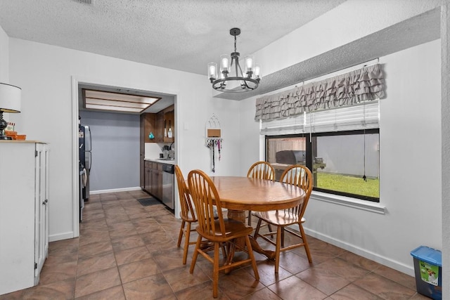 dining room featuring a chandelier, a textured ceiling, and baseboards