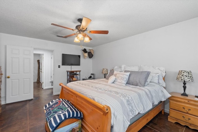 bedroom featuring a textured ceiling, ceiling fan, baseboards, and concrete floors