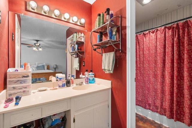 bathroom featuring ceiling fan, vanity, and a shower with curtain