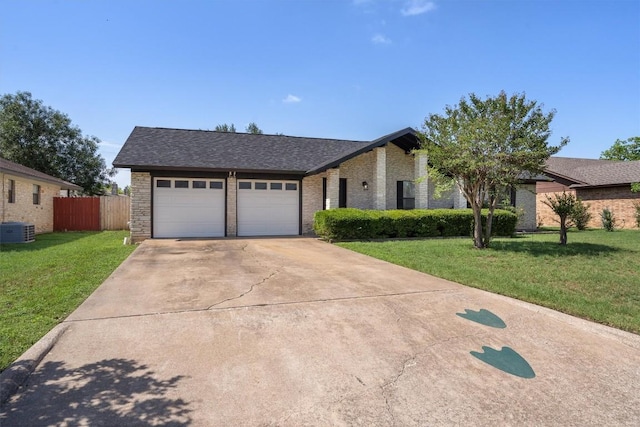 view of front of home featuring central air condition unit, brick siding, a garage, driveway, and a shingled roof